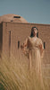 Amber Vigil apricot crepe Moroccan kaftan with a gold sequin mesh plastron at the neckline, in motion